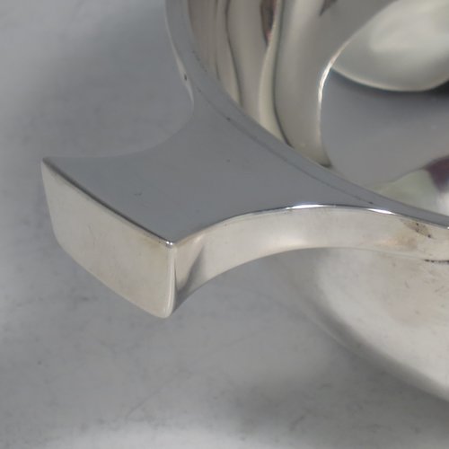 An Antique Victorian Sterling silver Scottish quaich, having a very plain round body, with two side handles, sitting on a collet foot. Made by Brook & Son of Edinburgh in 1889. The dimensions of this fine hand-made antique silver quaich are diameter of body 11 cms (4.25 inches), height 4 cms (1.5 inches), and it weighs approx. 145g (4.7 troy ounces).