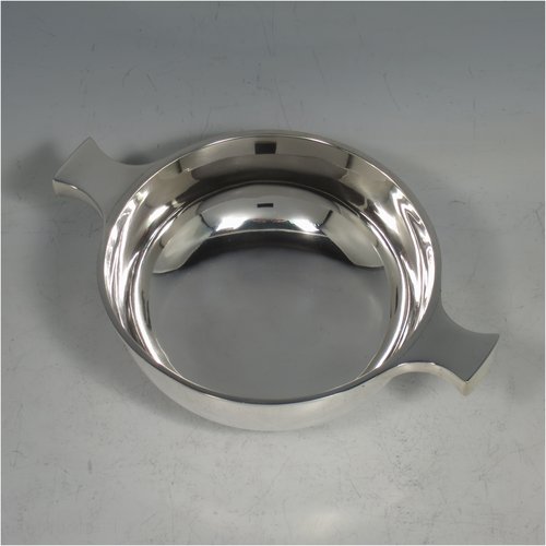 An Antique Victorian Sterling silver Scottish quaich, having a very plain round body, with two side handles, sitting on a collet foot. Made by Brook & Son of Edinburgh in 1889. The dimensions of this fine hand-made antique silver quaich are diameter of body 11 cms (4.25 inches), height 4 cms (1.5 inches), and it weighs approx. 145g (4.7 troy ounces).