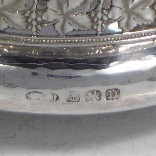 A Sterling silver Arts & Crafts style quaich, having a round baluster body with hand-hammered decoration, a hand-pierced grape-vine border, with two cast side-handles showing a scene with fox and tree, and all sitting on a flat base. Made by A. E. Jones of Birmingham in 1928. The dimensions of this fine hand-made silver Arts and Crafts quaich are diameter of body 12 cms (4.75 inches), height 4 cms (1.5 inches), and it weighs approx. 151g (4.9 troy ounces).