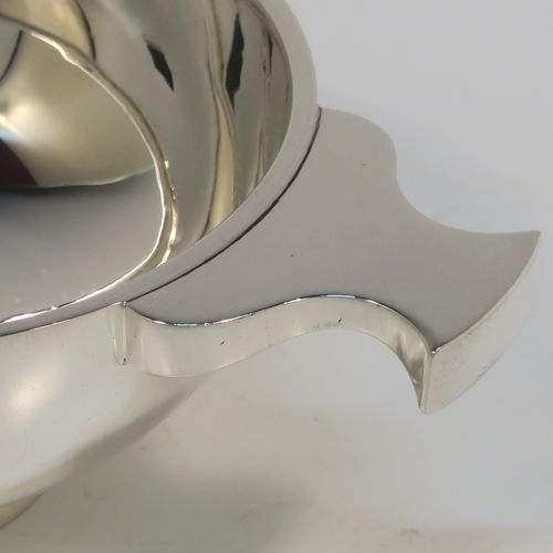 A handsome Scottish Sterling Silver Quaich, having a very plain round body, with two side handles, and sitting on a collet foot. This elegant silver Quaich was made by Davidson, Henderson, and Sorley of Glasgow in 1933. The dimensions of this fine hand-made silver Scottish Quaich are diameter of body 9 cms (3.5 inches), height 4 cms (1.5 inches), and it weighs approx. 116g (3.7 troy ounces).   