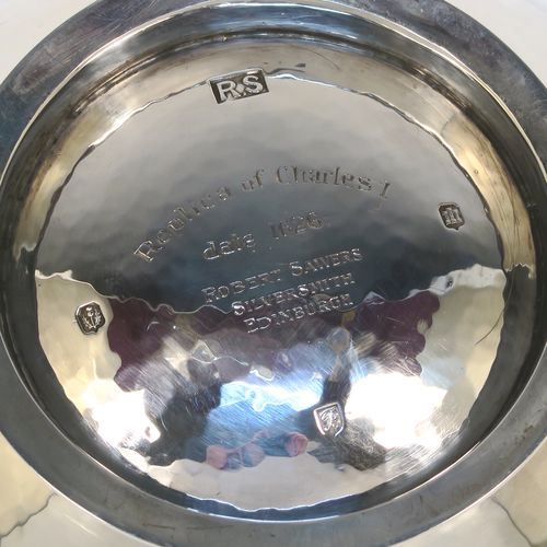 A large and very handsome Scottish Sterling Silver Quaich, having a very plain round body with hand-hammered decoration, with two cast side handles, and sitting on a pedestal foot. This elegant silver Quaich was made by Robert Sawyers of Edinburgh in 1932, and is a replica of an early Charles I Quaich from 1626. The dimensions of this fine hand-made Scottish Silver Quaich are diameter of body 15 cms (6 inches), height 5 cms (2 inches), and it weighs approx. 314g (10 troy ounces).   