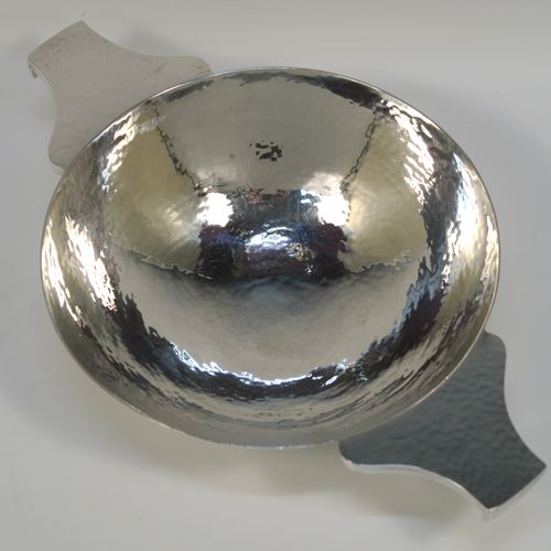 A large and very handsome Scottish Sterling Silver Quaich, having a very plain round body with hand-hammered decoration, with two cast side handles, and sitting on a pedestal foot. This elegant silver Quaich was made by Robert Sawyers of Edinburgh in 1932, and is a replica of an early Charles I Quaich from 1626. The dimensions of this fine hand-made Scottish Silver Quaich are diameter of body 15 cms (6 inches), height 5 cms (2 inches), and it weighs approx. 314g (10 troy ounces).   