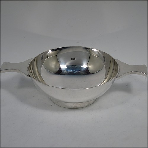 A very handsome and large Sterling Silver Scottish quaich, having a very plain round body, with two side handles, and sitting on a collet foot. Made by Mappin and Webb of Edinburgh in 1997. The dimensions of this fine hand-made silver quaich are diameter of body 13 cms (5 inches), height 5 cms (2 inches), and it weighs approx. 318g (10 troy ounces).    