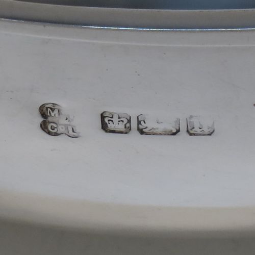 A handsome and large Antique Edwardian Sterling Silver Quaich, having a very plain round body, with two side handles, and sitting on a collet foot. This elegant antique silver Quaich was made by Martin Hall and Co. Ltd., of Sheffield in 1905. The dimensions of this fine hand-made antique silver Quaich are diameter of body 16.6 cms (6.5 inches), height 6 cms (2.3 inches), and it weighs approx. 350g (11 troy ounces).