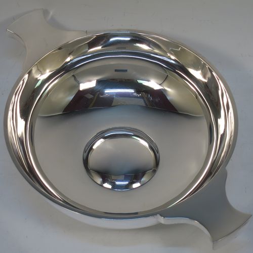 A handsome and large Antique Edwardian Sterling Silver Quaich, having a very plain round body, with two side handles, and sitting on a collet foot. This elegant antique silver Quaich was made by Martin Hall and Co. Ltd., of Sheffield in 1905. The dimensions of this fine hand-made antique silver Quaich are diameter of body 16.6 cms (6.5 inches), height 6 cms (2.3 inches), and it weighs approx. 350g (11 troy ounces).