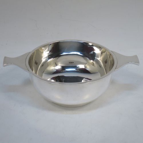A very handsome Sterling Silver Scottish quaich, having a very plain round body, with two side handles, and sitting on a collet foot. Made by Mackay and Chisholm  of Edinburgh in 1929. The dimensions of this fine hand-made silver quaich are diameter of body 11.5 cms (4.5 inches), height 5 cms (2 inches), and it weighs approx. 172g (5.5 troy ounces).   