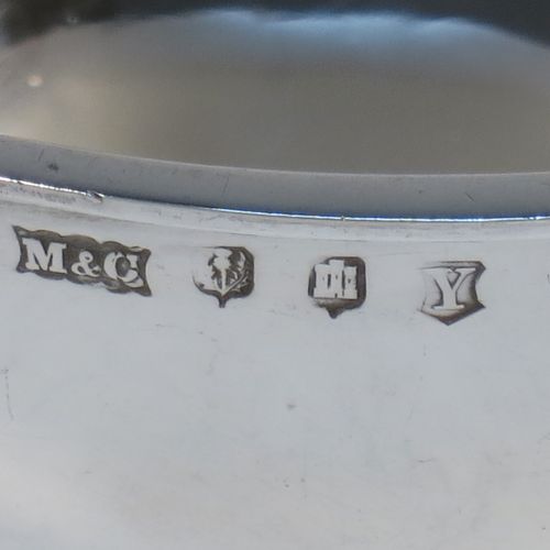 A very handsome Sterling Silver Scottish quaich, having a very plain round body, with two side handles, and sitting on a collet foot. Made by Mackay and Chisholm of Edinburgh in 1929. The dimensions of this fine hand-made silver quaich are diameter of body 11.5 cms (4.5 inches), height 5 cms (2 inches), and it weighs approx. 172g (5.5 troy ounces).