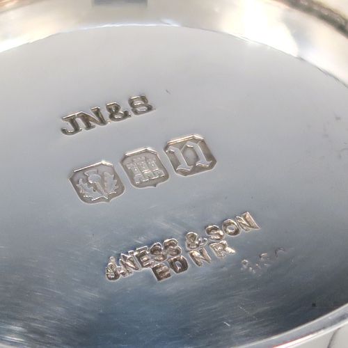 A handsome Scottish Sterling Silver Quaich, having a very plain round body, with two side handles, and sitting on a collet foot. This elegant silver Quaich was made by James Ness and Son of Edinburgh in 1968. The dimensions of this fine hand-made silver Scottish Quaich are diameter of body 9 cms (3.5 inches), height 4 cms (1.5 inches), and it weighs approx. 120g (3.9 troy ounces).   
