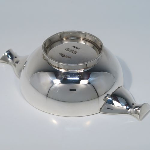 A handsome Scottish Sterling Silver Quaich, having a very plain round body, with two side handles, and sitting on a collet foot. This elegant silver Quaich was made by James Ness and Son of Edinburgh in 1968. The dimensions of this fine hand-made silver Scottish Quaich are diameter of body 9 cms (3.5 inches), height 4 cms (1.5 inches), and it weighs approx. 120g (3.9 troy ounces).   