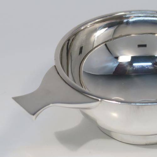 A handsome Scottish Sterling Silver Quaich, having a very plain round body, with two side handles, and sitting on a collet foot. This elegant silver Quaich was made by James Ness and Son of Edinburgh in 1968. The dimensions of this fine hand-made silver Scottish Quaich are diameter of body 9 cms (3.5 inches), height 4 cms (1.5 inches), and it weighs approx. 120g (3.9 troy ounces).   
