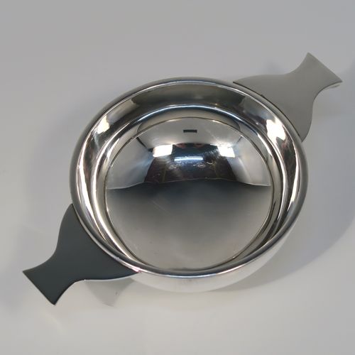 A handsome Scottish Sterling Silver Quaich, having a very plain round body, with two side handles, and sitting on a collet foot. This elegant silver Quaich was made by James Ness and Son of Edinburgh in 1968. The dimensions of this fine hand-made silver Scottish Quaich are diameter of body 9 cms (3.5 inches), height 4 cms (1.5 inches), and it weighs approx. 120g (3.9 troy ounces).   