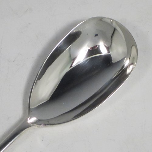 Sterling silver pair of salad servers, having very plain oval bowls, featuring long handles with hand-chased shaped gadroon an floral terminals. Made by Goldsmiths and Silversmiths of Sheffield in 1920. The length of these fine hand-made silver salad servers are 28 cms (11 inches), and the total weight is approx. 196g (6.3 troy ounces).
