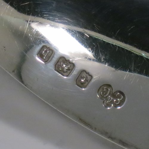 An Antique Edwardian Sterling Silver pair of Arts and Crafts salad servers, having very plain bodies with oval bowls, featuring tapered handles with chamfered ends. Made by Elkington & Co., of Birmingham in 1907. The length of these fine hand-made antique silver salad servers are 27 cms (10.75 inches), and the total weight is approx. 132g (4.3 troy ounces).