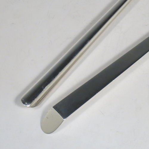 An Antique Edwardian Sterling Silver pair of Arts and Crafts salad servers, having very plain bodies with oval bowls, featuring tapered handles with chamfered ends. Made by Elkington & Co., of Birmingham in 1907. The length of these fine hand-made antique silver salad servers are 27 cms (10.75 inches), and the total weight is approx. 132g (4.3 troy ounces).