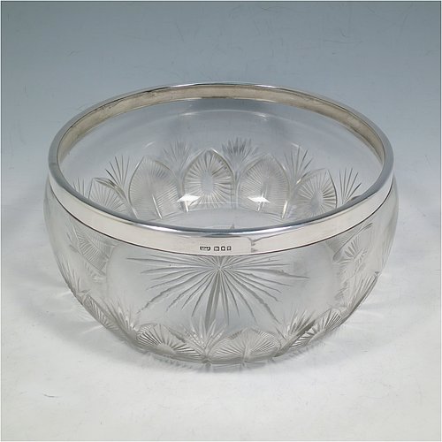 A Sterling Silver and hand-cut crystal salad bowl, having a round body with a plain applied silver rim, sitting on a hand-cut crystal base with floral and leaf engraving, and a star-cut flat base. Made by BS & Co., of London in 1921. The dimensions of this fine hand-made silver and crystal salad bowl are diameter 21 cms (8.25 inches), and height 11 cms (4.25 inches).   