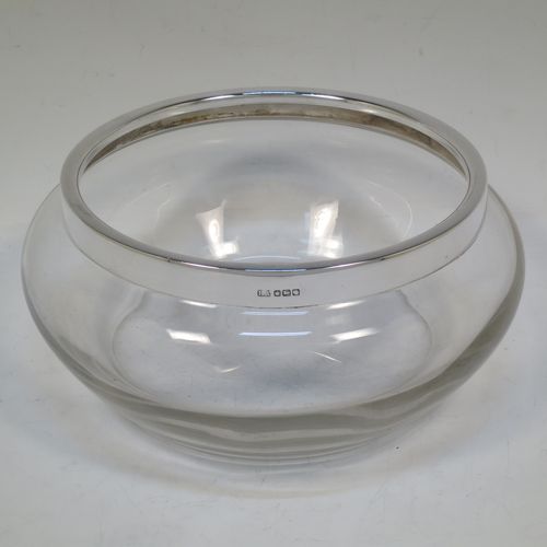 A handsome Antique Sterling Silver and hand-cut crystal salad bowl, having a plain round body with a plain applied silver rim, and all sitting on a flat base. Made by Henry Atkins of Sheffield in 1914. The dimensions of this fine hand-made antique silver and crystal salad bowl are diameter 23 cms (9 inches), and height 10 cms (4 inches).   