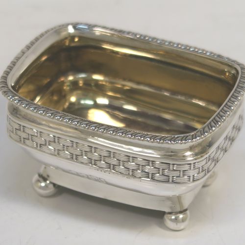 A very unusual and elegant pair of Antique Georgian Regency Sterling Silver salt cellars, having rectangular bellied bodies with rounded corners, decorated with gadroon top borders and central applied bands of basket-weave, with gold-gilt interiors and sitting on four ball feet. These beautiful antique silver salt cellars were hallmarked for London in 1809. The dimensions of these fine hand-made antique silver salt cellars are length 8 cms (3 inches), width 6 cms (2.3 inches), height 4.5 cms (1.75 inches), and they weigh a total of approx. 183g (5.9 troy ounces).