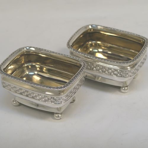 A very unusual and elegant pair of Antique Georgian Regency Sterling Silver salt cellars, having rectangular bellied bodies with rounded corners, decorated with gadroon top borders and central applied bands of basket-weave, with gold-gilt interiors and sitting on four ball feet. These beautiful antique silver salt cellars were hallmarked for London in 1809. The dimensions of these fine hand-made antique silver salt cellars are length 8 cms (3 inches), width 6 cms (2.3 inches), height 4.5 cms (1.75 inches), and they weigh a total of approx. 183g (5.9 troy ounces).