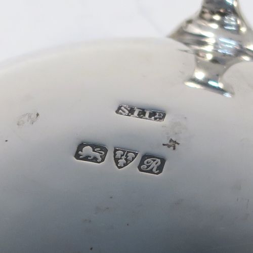A very handsome pair of Antique Sterling Silver salt cellars, having plain round bellied bodies, with blue-glass liners, applied shaped gadroon borders, and all sitting on three cast hoof feet with reeded shoulders. These elegant silver salt cellars were made by Stokes and Ireland of Chester in 1919. The dimensions of these fine hand-made antique silver salt cellars are diameter 6 cms (2.3 inches), height 3.5 cms (1.3 inches), and they weigh a total of approx. 99g (3.2 troy ounces).