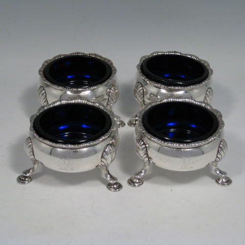 A very handsome Antique Georgian Sterling Silver set of four cauldron salt cellars having plain round bellied bodies, with applied gadroon top borders, and siting on three cast hoof feet. These elegant silver salt cellars were made by David Hennell I of London in 1759. The dimension of this antique silver set of four salt cellars are diameter 7 cms (2.75 inches), height 4.5 cms (1.75 inches), and with a total weight approx. 10 troy ounces (310g). Please note that these salts have engraved crests.