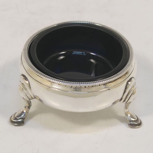 A very handsome Antique Georgian Sterling Silver pair of George III cauldron salt cellars, having plain round bodies, with rope-twist borders, blue glass liners, and sitting on three cast hoof feet. These elegant antique silver cauldron salt cellars were made in London in 1768. The dimensions of these fine hand-made silver salt cellars are diameter 6 cms (2.3 inches), height 3.5 cms (1.3 inches), and they weigh a total of approx. 80g (2.6 troy ounces)