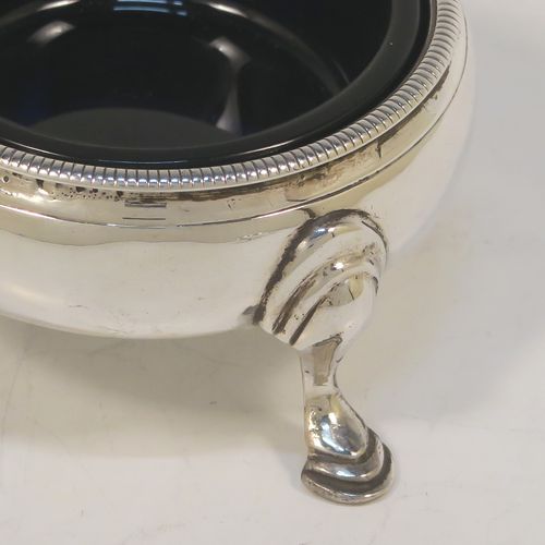 A very handsome Antique Georgian Sterling Silver pair of George III cauldron salt cellars, having plain round bodies, with rope-twist borders, blue glass liners, and sitting on three cast hoof feet. These elegant antique silver cauldron salt cellars were made in London in 1768. The dimensions of these fine hand-made silver salt cellars are diameter 6 cms (2.3 inches), height 3.5 cms (1.3 inches), and they weigh a total of approx. 80g (2.6 troy ounces)