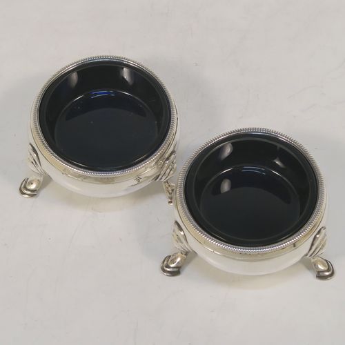 A very handsome Antique Georgian Sterling Silver pair of George III cauldron salt cellars, having plain round bodies, with rope-twist borders, blue glass liners, and sitting on three cast hoof feet. These elegant antique silver cauldron salt cellars were made in London in 1768. The dimensions of these fine hand-made silver salt cellars are diameter 6 cms (2.3 inches), height 3.5 cms (1.3 inches), and they weigh a total of approx. 80g (2.6 troy ounces)