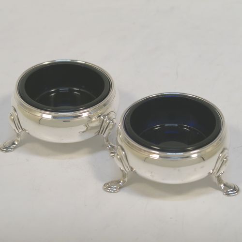 A very handsome Antique Georgian Sterling Silver pair of George II cauldron salt cellars, having plain round bodies, with reeded borders, blue glass liners, and sitting on three cast hoof feet. These elegant antique silver cauldron salt cellars were made by Edward Wood of London in 1746. The dimensions of these fine hand-made silver salt cellars are diameter 6 cms (2.3 inches), height 3 cms (1.25 inches), and they weigh a total of approx. 94g (2 troy ounces).   