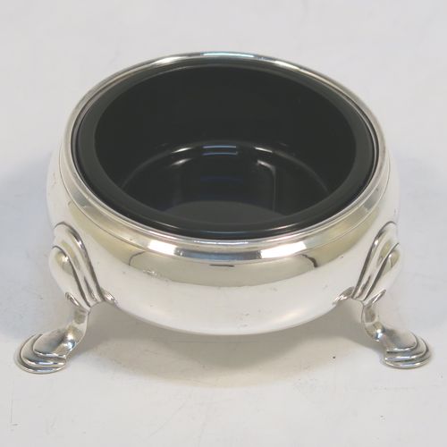 A very handsome Antique Georgian Sterling Silver pair of George II cauldron salt cellars, having plain round bodies, with reeded borders, blue glass liners, and sitting on three cast hoof feet. These elegant antique silver cauldron salt cellars were made by Edward Wood of London in 1746. The dimensions of these fine hand-made silver salt cellars are diameter 6 cms (2.3 inches), height 3 cms (1.25 inches), and they weigh a total of approx. 94g (2 troy ounces).