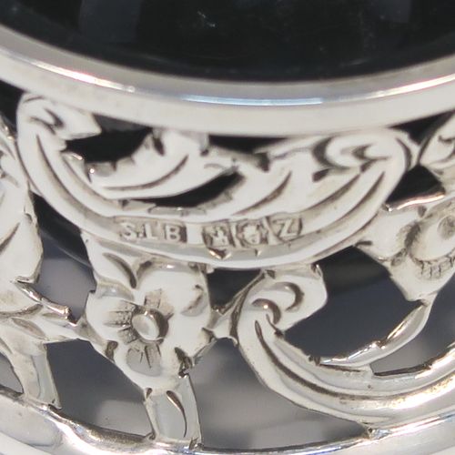 A very unusual and pretty pair of Irish Antique Victorian Sterling Silver salt cellars, in the shape of miniature potato or dish rings, having round bodies with hand-chased and hand-pierced concave shaped sides, together with hand-blown blue glass liners. These interesting antique silver salt cellars in a Potato dish ring style were made by Samuel Le Bas of Dublin in 1895. The dimensions of these fine hand-made silver salt cellars are diameter 5 cms (2 inches), height 3 cms (1.25 inches), and they weigh a total of approx. 65g (2 troy ounces).