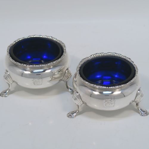 A very handsome pair of Antique Victorian Sterling Silver salt cellars, having plain round bellied bodies, with blue-glass liners, applied shaped gadroon borders, and all sitting on three cast hoof feet with reeded shoulders. These elegant silver salt cellars were made by Francis Boone Thomas of London in 1874. The dimensions of these fine hand-made antique silver salt cellars are diameter 6.5 cms (2.5 inches), height 4 cms (1.5 inches), and they weigh a total of approx. 128g (4 troy ounces).  