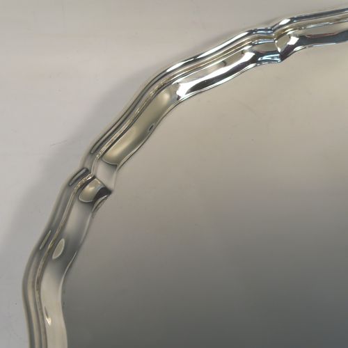 A very handsome Sterling Silver salver, having an applied shaped and reeded Bath border, a plain ground, and sitting on four cast hoof feet. This elegant and large silver salver was made by Charles Boytons and Sons of Sheffield in 1932. The dimensions of this fine hand-made silver salver are diameter 36 cms (14 inches), and it weighs approx. 1,270g (41 troy ounces).