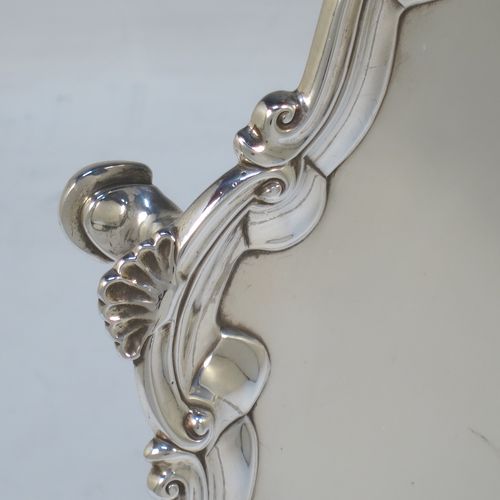 A very elegant Antique Georgian Sterling Silver salver, having an applied shell and scroll border, a plain ground, and sitting on three cast hoof feet. Made by Richard Rugg of London in 1760. The dimensions of this fine hand-made antique silver salver are diameter 33 cms (13 inches), height 4 cms (1.5 inches), and it weighs approx. 875g (28 troy ounces)
