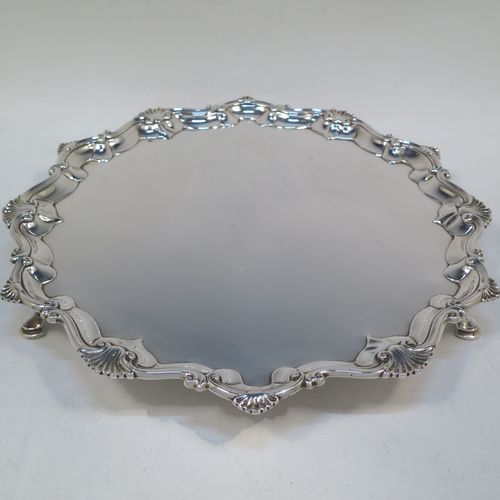 A very elegant Antique Georgian Sterling Silver salver, having an applied shell and scroll border, a plain ground, and sitting on three cast hoof feet. Made by Richard Rugg of London in 1760. The dimensions of this fine hand-made antique silver salver are diameter 33 cms (13 inches), height 4 cms (1.5 inches), and it weighs approx. 875g (28 troy ounces)