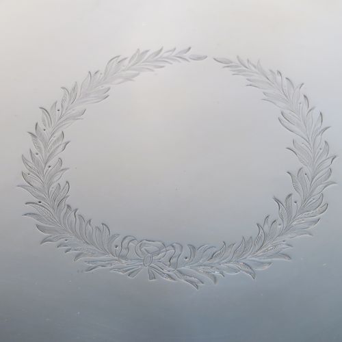 A very elegant Antique Georgian Sterling Silver salver, having an applied shaped gadroon border, a plain ground with a central laurel leaf cartouche., and sitting on three cast scroll and shell feet. This beautiful antique silver salver was made by Hanham and Crouch of London in 1801. The dimensions of this fine hand-made silver salver are diameter 37 cms (14.5 inches), and it weighs approx. 1,288g (41.5 troy ounces).
