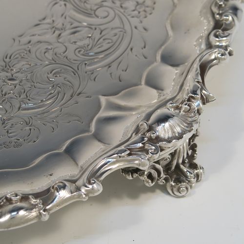 A beautiful Antique early Victorian Sterling Silver salver, having an applied cast shell and scroll border, the ground having hand-chased floral and scroll decoration surrounding a central vacant cartouche, and all sitting on three cast and pierced scroll feet. This fantastic salver was made by the most important 19th century British silversmith Paul Storr of London in 1838. The dimensions of this fine hand-made antique silver salver are diameter 32 cms (12.3 inches), height 4 cms (1.5 inches), and it weighs approx. 1,006g (32.5 troy ounces).