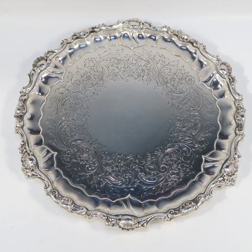 A beautiful Antique early Victorian Sterling Silver salver, having an applied cast shell and scroll border, the ground having hand-chased floral and scroll decoration surrounding a central vacant cartouche, and all sitting on three cast and pierced scroll feet. This fantastic salver was made by the most important 19th century British silversmith Paul Storr of London in 1838. The dimensions of this fine hand-made antique silver salver are diameter 32 cms (12.3 inches), height 4 cms (1.5 inches), and it weighs approx. 1,006g (32.5 troy ounces).