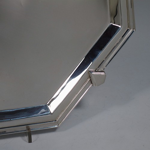 A very handsome and striking Art Deco Sterling Silver salver, having an octagonal body with an applied reeded border, with a plain burnished ground, and sitting on four cast panelled feet. Made by Charles William Fletcher of Sheffield in 1936. The dimensions of this fine hand-made Art Deco style silver salver are 34 cms (13.5 inches) diameter, and it weighs approx. 992g (32 troy ounces).