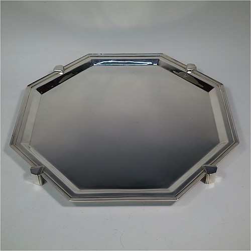 A very handsome and striking Art Deco Sterling Silver salver, having an octagonal body with an applied reeded border, with a plain burnished ground, and sitting on four cast panelled feet. Made by Charles William Fletcher of Sheffield in 1936. The dimensions of this fine hand-made Art Deco style silver salver are 34 cms (13.5 inches) diameter, and it weighs approx. 992g (32 troy ounces).