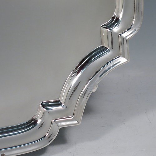 A Sterling Silver salver, having a square cut-corner body, with a plain burnished ground, an applied cut-corner border, and sitting on four cast hoof feet. Made by Robert Pringle of London in 1935. The dimensions of this fine hand-made silver salver are 34 cms (13.5 inches) square, and it weighs approx. 1,116g (36 troy ounces).