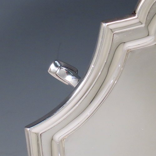 A Sterling Silver salver, having a square cut-corner body, with a plain burnished ground, an applied cut-corner border, and sitting on four cast hoof feet. Made by Robert Pringle of London in 1935. The dimensions of this fine hand-made silver salver are 34 cms (13.5 inches) square, and it weighs approx. 1,116g (36 troy ounces).