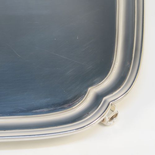 A very elegant Sterling Silver salver, having a square body with shaped and cut corners, a plain burnished ground, an applied reeded border, and sitting on four cast scroll feet. This handsome silver salver was made by S. Blankensee and Sons Ltd., of Birmingham in 1937. The dimensions of this fine hand-made silver salver are 34.5 cms (13.5 inches) square, and it weighs approx. 1,210g (39 troy ounces).