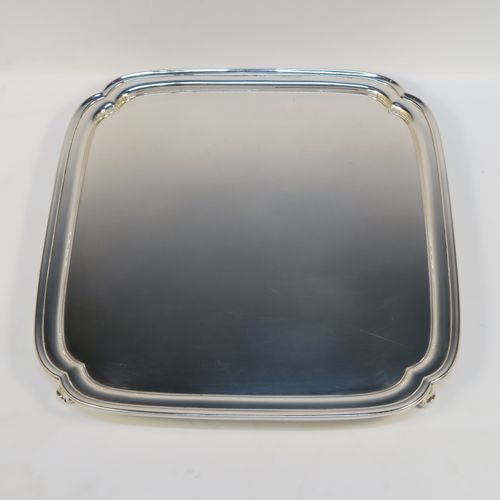 A very elegant Sterling Silver salver, having a square body with shaped and cut corners, a plain burnished ground, an applied reeded border, and sitting on four cast scroll feet. This handsome silver salver was made by S. Blankensee and Sons Ltd., of Birmingham in 1937. The dimensions of this fine hand-made silver salver are 34.5 cms (13.5 inches) square, and it weighs approx. 1,210g (39 troy ounces).