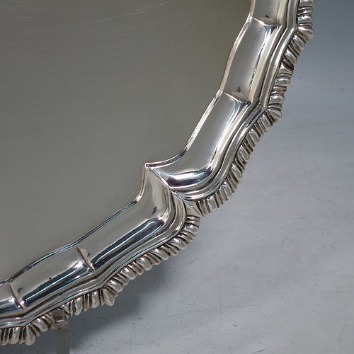 A very handsome Antique Georgian Irish Sterling Silver salver, having an applied shaped gadroon border, a plain ground with a hand-engraved armorial central crest and Latin motto, and sitting on four cast hoof feet. This elegant Irish antique silver salver was made in Dublin, Ireland, in 1796. The dimensions of this fine hand-made antique silver salver are diameter 36 cms (14.25 inches), and it weighs approx. 1,190g (38 troy ounces).