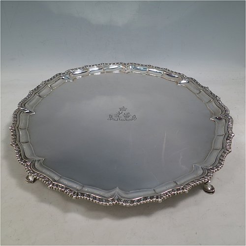 A very handsome Antique Georgian Irish Sterling Silver salver, having an applied shaped gadroon border, a plain ground with a hand-engraved armorial central crest and Latin motto, and sitting on four cast hoof feet. This elegant Irish antique silver salver was made in Dublin, Ireland, in 1796. The dimensions of this fine hand-made antique silver salver are diameter 36 cms (14.25 inches), and it weighs approx. 1,190g (38 troy ounces).