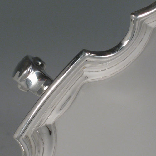 Sterling silver large salver, having a Chippendale border, plain ground, and sitting on three cast scroll feet. Made by the Adie Brothers of Birmingham in 1927. Diameter 36 cms (14 inches). Weight approx. 1,270g (41 troy ounces).
