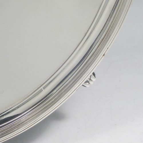 A handsome Antique Georgian Sterling Silver salver, having an applied reeded border, a plain ground with a hand-engraved armorial central crest, and sitting on four cast reeded feet. This elegant antique silver salver was made by Thomas Wallis II of London in 1796. The dimensions of this fine hand-made antique silver salver are diameter 33 cms (13 inches), and it weighs approx. 1,062g (34.3 troy ounces).