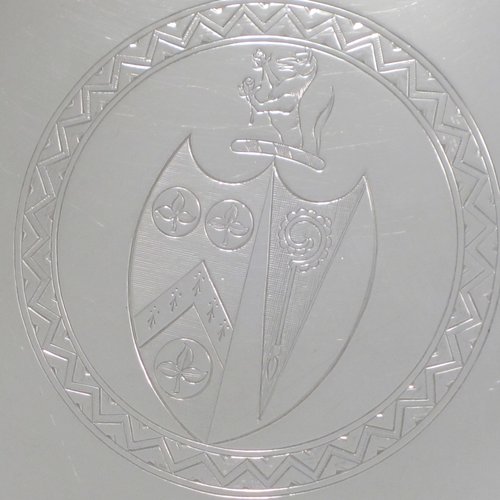 A handsome Antique Georgian Sterling Silver salver, having an applied reeded border, a plain ground with a hand-engraved armorial central crest, and sitting on four cast reeded feet. This elegant antique silver salver was made by Thomas Wallis II of London in 1796. The dimensions of this fine hand-made antique silver salver are diameter 33 cms (13 inches), and it weighs approx. 1,062g (34.3 troy ounces).