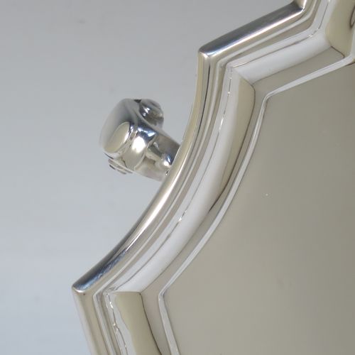 A very handsome Sterling Silver salver, having a square cut-corner body, with a plain burnished ground, an applied cut-corner border, and sitting on four cast scroll feet. Made by Goldsmiths and Silversmiths of London in 1928. The dimensions of this fine hand-made silver salver are 30.5 cms (12 inches) square, and it weighs approx. 958g (31 troy ounces).
