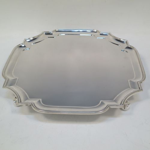 A very handsome Sterling Silver salver, having a square cut-corner body, with a plain burnished ground, an applied cut-corner border, and sitting on four cast scroll feet. Made by Goldsmiths and Silversmiths of London in 1928. The dimensions of this fine hand-made silver salver are 30.5 cms (12 inches) square, and it weighs approx. 958g (31 troy ounces).